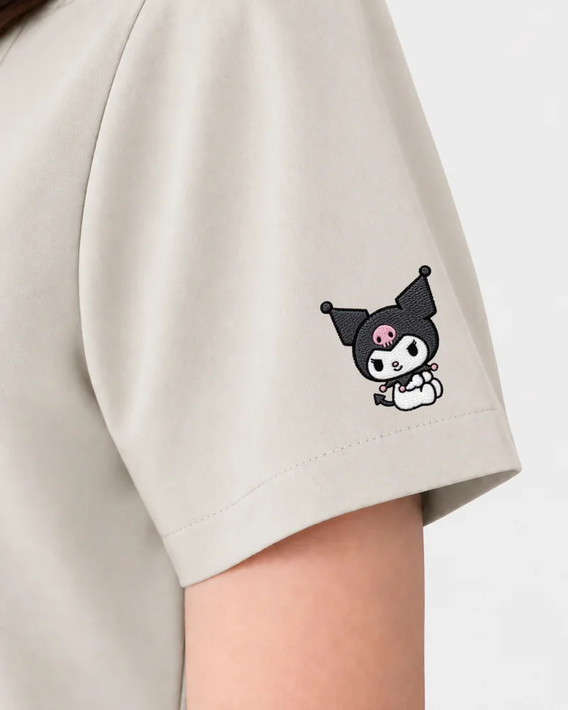 Kuromi Medical Scrub in Vanilla Cream: the sleeve embroidery