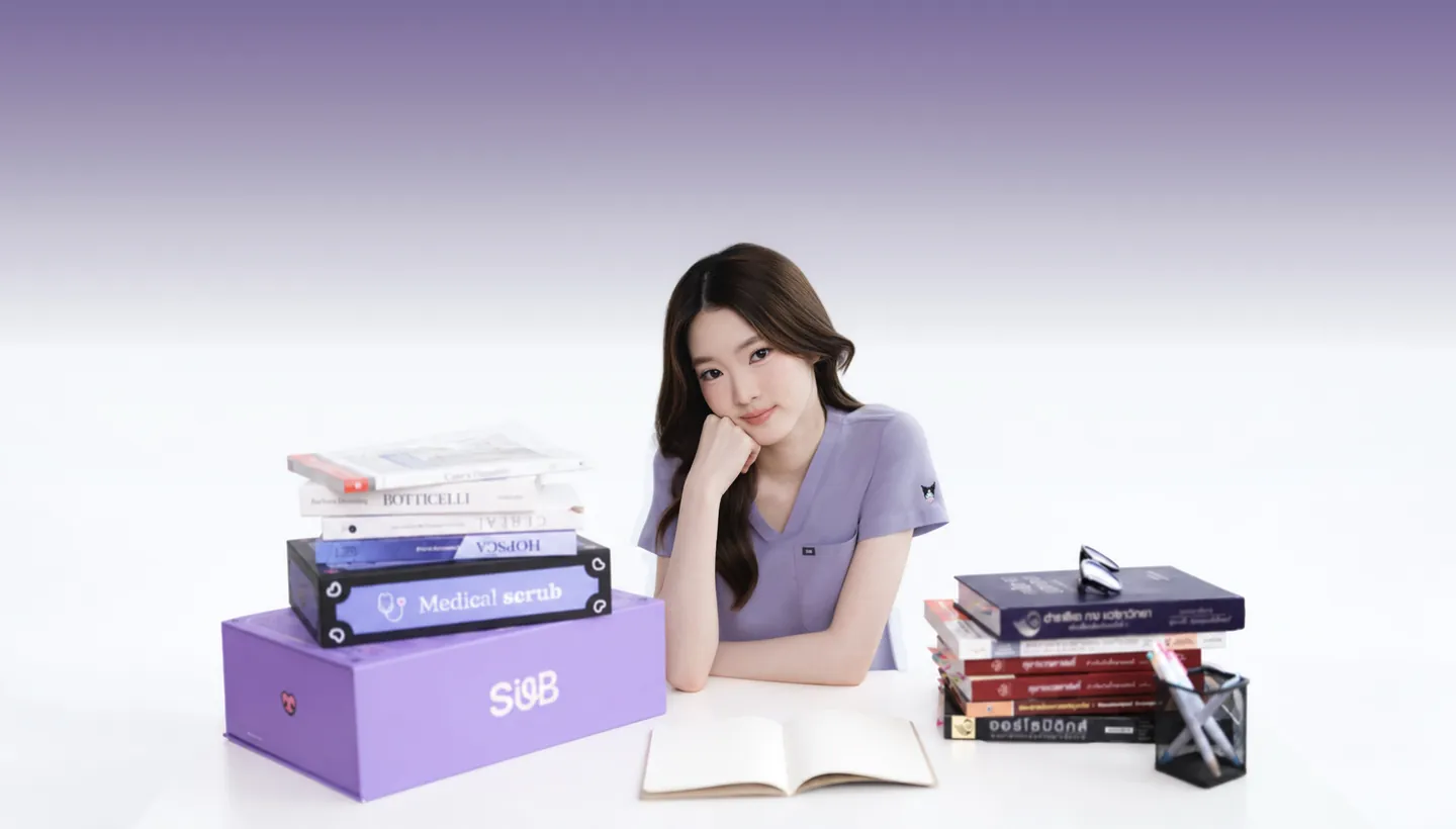 A woman in the lilac Kuromi Medical Scrub, chin on her hand at a white desk, between stacks of medical textbooks and the SUB. Medical Scrub box